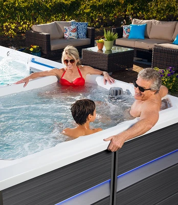 Dual-temperature swim spa with separate hot tub and swim training zones