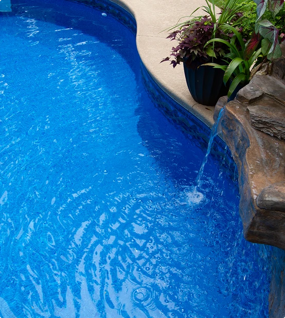 Close up of an Optimum Pool with a rock waterfall feature